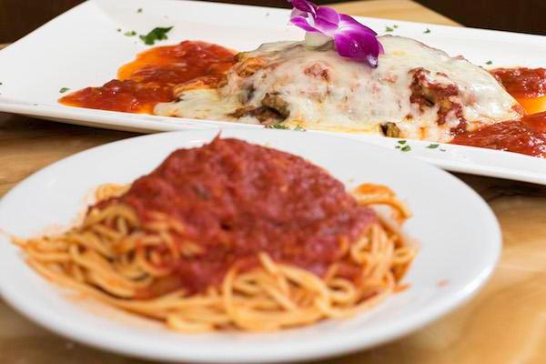 Eggplant Parmigiana · Lightly breaded skinless eggplant covered with tomato sauce and mozzarella cheese. Served with side salad, your choice of pasta or roasted potatoes and vegetables.