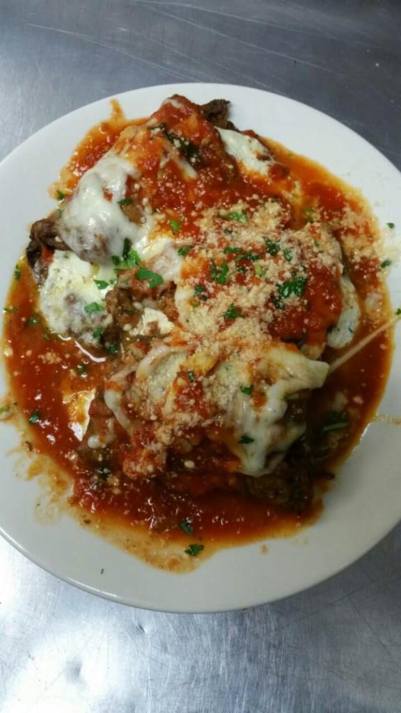 Eggplant Rollatini · Eggplant stuffed with ricotta, covered with sauce and melted mozzarella cheese. Served with side salad, your choice of pasta or roasted potatoes and vegetables.