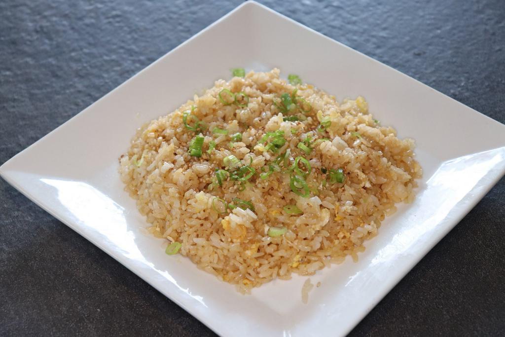 Plain Fried Rice · Pan-fried rice and egg topped with green onions and sesame seeds.
