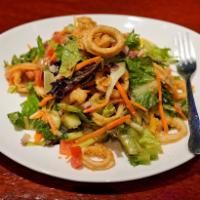 Asian Calamari Salad · Tender fried calamari, fresh vegetables, field greens and sesame ginger dressing.