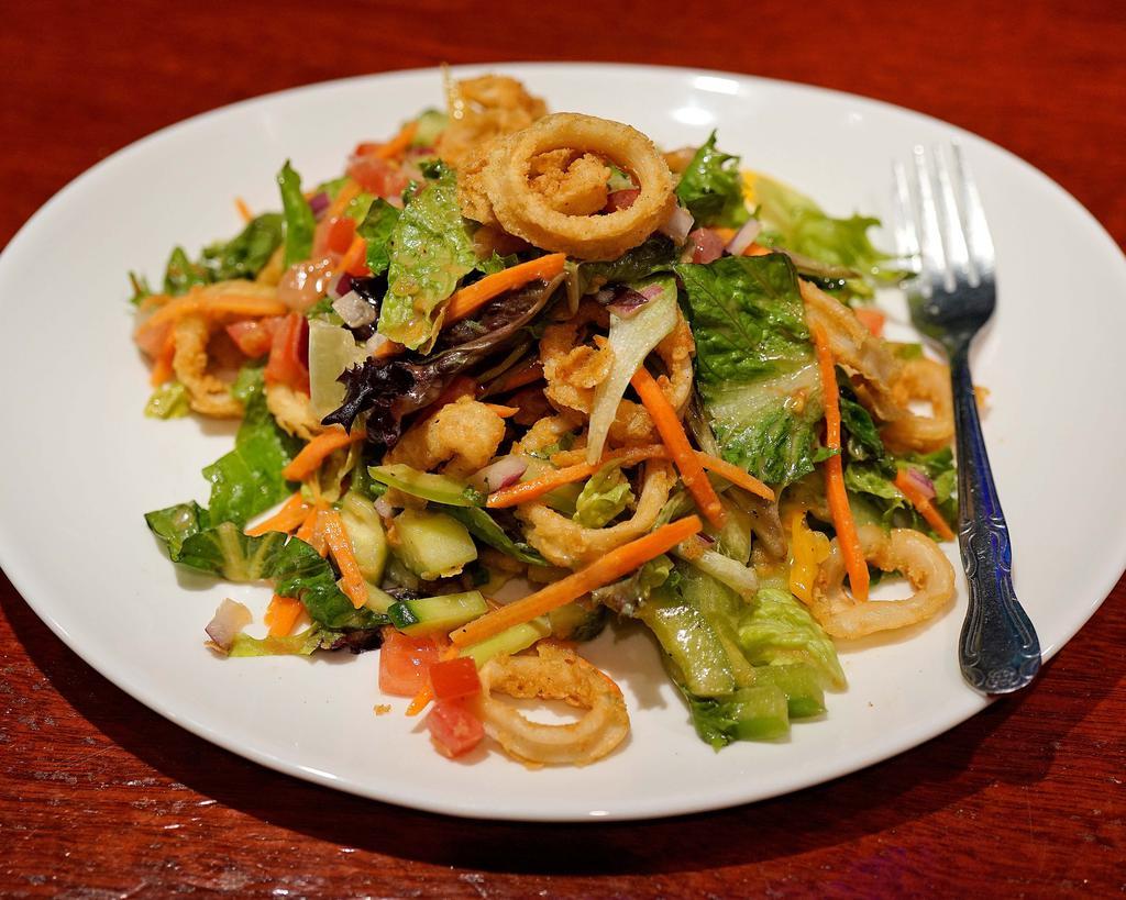 Asian Calamari Salad · Tender fried calamari, fresh vegetables, field greens and sesame ginger dressing.