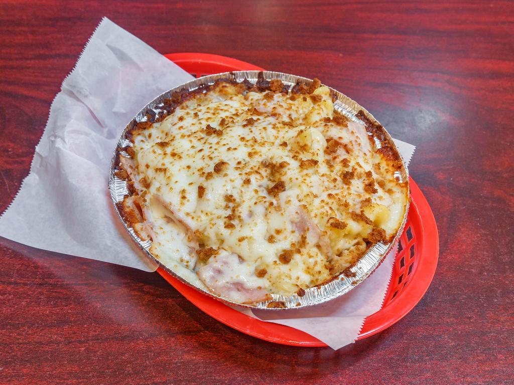 Mac & Cheese Pizza · Nacho cheese base, shredded mozzarella, macaroni and cheese, Canadian bacon, and seasoned bread crumbs. Substitute the bacon for Beyond Meat for an additional charge.