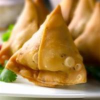 Samosa · Seasoned potato and peas wrapped in a light pastry pouch. Veggie. 