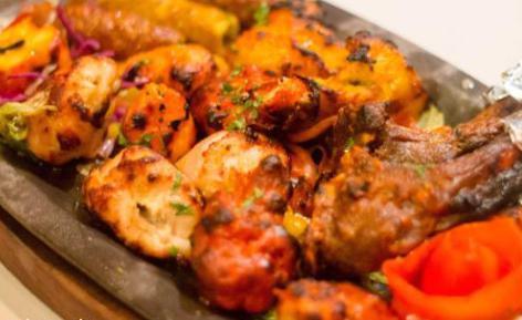 Tandoori Platter · Sampler of chicken tikka, malai kabab, lamb, kabab, reshmi kabab and herbed tandoori shrimp,served with rice, yellow lentils and freshly baked tandoori naan. 