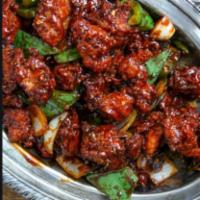 Chili Chicken · Cooked in a tangy tomato sauce with onions, ginger, green chiles and a hit of soy sauce. Spi...