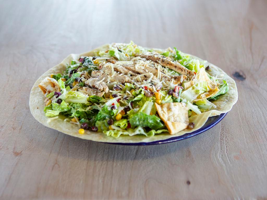 Caesar Salad with Chicken · Charbroiled chicken breast, romaine lettuce, red onions, garlic tortilla chips, black bean-corn salsa, Caesar dressing and Parmesan cheese.