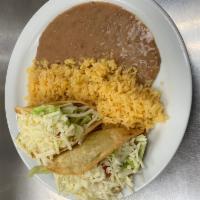 2. Two Hard Tacos · 2 fried corn tortillas with choice of shredded beef, chicken or potato topped with lettuce, ...