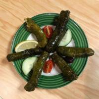6 Dolma · Hand rolled grape leaves stuffed with rice, chickpeas, tomatoes, onions, parsley and spices.