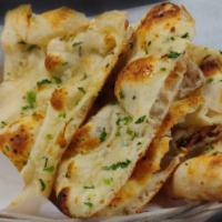 Garlic Naan · (Top seller) Naan covered in layer of homemade garlic cream, topped with fresh cilantro.