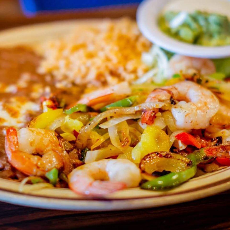 Shrimp Fajitas · Grilled shrimp sauteed with onions, bell peppers, tomatoes and garlic. Served with rice and beans, a side of tortillas and a side of sour cream and guacamole.