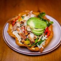 26. Fajita Salad · Grilled chicken or steak on a bed of greens with bell peppers, onion, avocado, tomato and ch...