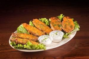 6 Potato Skins · Fresh skins stuffed with cheddar cheese, bacon and chives then baked to perfection. Served w...