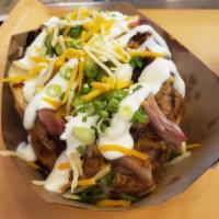 Smokehouse Loaded Potato · Topped with butter, cheddar cheese sauce, choice of smoked meat, shredded cheddar-jack mix, ...