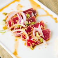 A14 Tuna Tataki · 5 pieces. Seared tuna, garlic flakes, red onion, green onion and ponzu sauce.