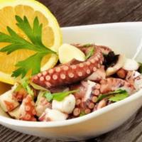 Octopus Salad · Salad, grilled octopus, tomato cubes, red onion, vinaigrette.