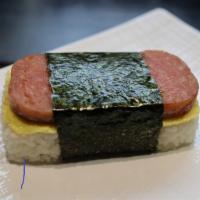 Musubi · Pan-fried spam slice layered with egg and seasoned rice. Wrapped in roasted seaweed
