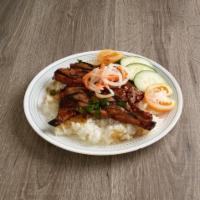 32. Grilled Pork Rice Platters / Com Suon Nuong · Char-broiled pork chop with steamed rice.