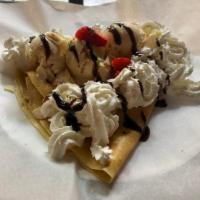 Sundae Crepe · Vanilla ice cream, chocolate syrup, strawberries and whipped cream