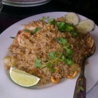 85. Pineapple Fried Rice · Fried rice with prawns, chicken, pork with pineapple and cashew nuts.