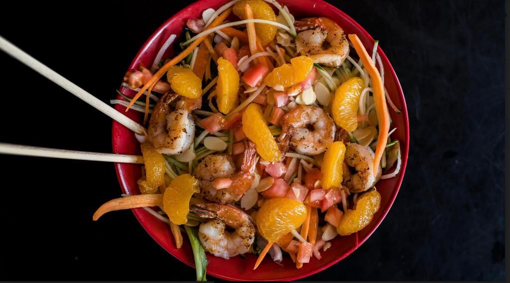 Asian Garden Salad · Sauteed butterflied shrimp over mixed greens, tomatoes, carrots, red peppers, toasted almonds and mandarin oranges with lime orange ginger vinaigrette. Gluten free.
