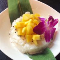 Mango Sticky Rice · Sweet Coconut rice, ripe mangos and crispy coconut flakes.