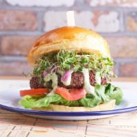 Homemade Veggie Burger · a blend of fresh vegetables rolled in red quinoa, fried crispy, ＆ served on a brioche bun wi...