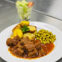Old-Fashioned Beef Stew · Chunks of beef slowly cooked over 2 hours, served with roasted potato & peas. Come w/House S...