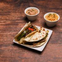 Fajita Taco Plate · 2 beef or chicken fajita tacos topped with onions and bell peppers. Served with Rice and cho...