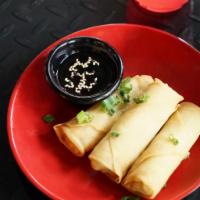 Crispy Veggie Spring Rolls · Deep-fried vegetable spring rolls served with house-made sweet and sour sauce.