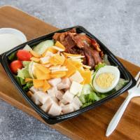 Turkey Club Salad · Tossed greens with cubed turkey breast, bacon, cheddar, Swiss, cucumbers and a halved hard-b...