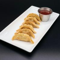 Pot Stickers  · Fried chicken pot stickers, gyoza, dumplings with a side of sweet and sour sauce.