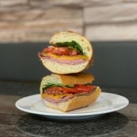 American Sandwich · Cured turkey, bacon, Cheddar, tomato, mixed greens and garlic aioli; toasted on a french roll