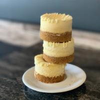 Vanilla Bean Cheesecake · our house-made cheesecake infused with real vanilla bean, drizzled with white chocolate; sit...