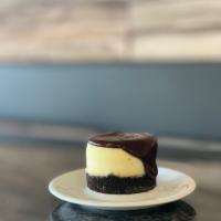 Chocolate Ganache Cheesecake · our house-made cheesecake topped with a thick layer of rich chocolate ganache, sitting on an...
