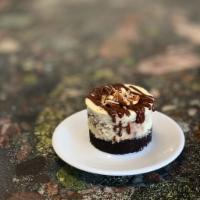 German Chocolate Cheesecake · Our house-made cheesecake swirled with coconut pecan filling and chocolate ganache; on an or...
