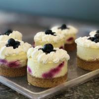 Lemon Blueberry Cheesecake · Our house-made cheesecake infused with lemon and swirled with blueberries; on a graham crack...