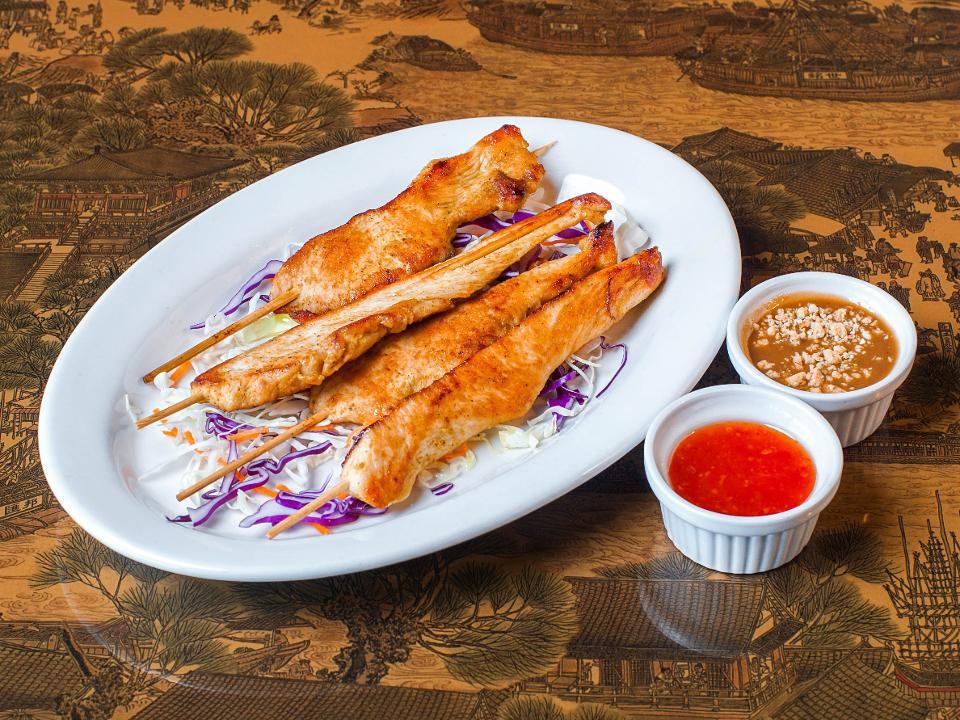 Chicken Satay (4) · Charcoal-grilled chicken tenders marinated in a blend of Thai herbs. Served with peanut sauce and sweet Thai chili sauce.