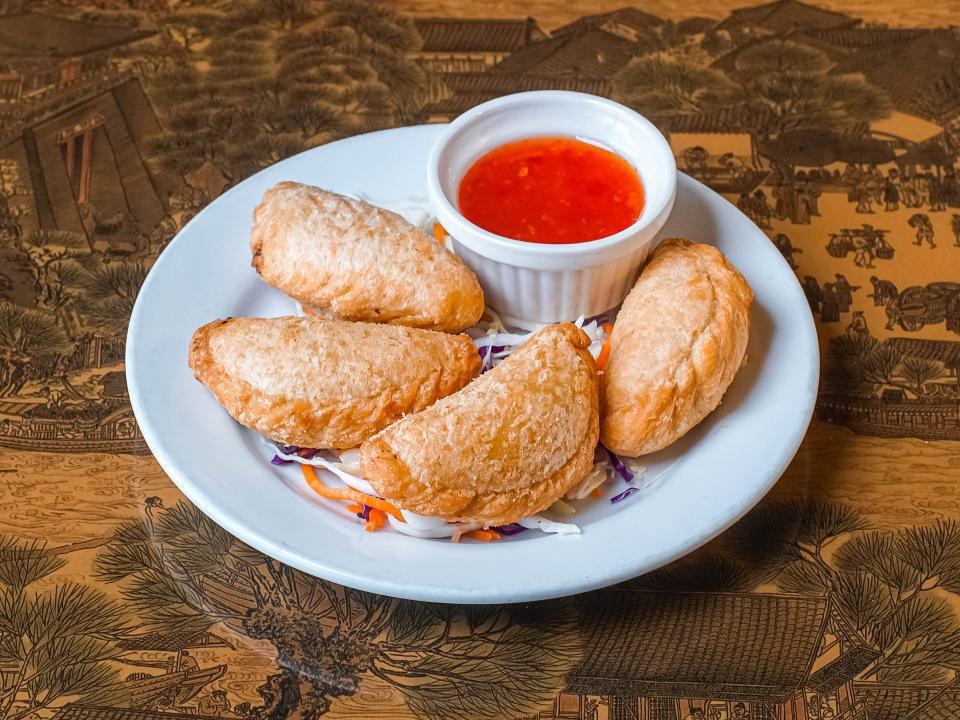 Curry Puff (4) · Puff pastries filled with chicken, onion, potato, savory curry seasoning. Served with sweet Thai chili sauce.