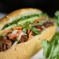 Grilled Pork Sandwich · Stuffed with Vietnamese style mayo, fresh cucumber, cilantro, pickled daikon and carrots.