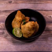 Vegetable Samosa · 2 deep-fried crisp patties filled with mildly spiced potatoes and peas.