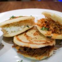Trio de Arepas · 3 pieces grilled cornmeal cakes stuffed with cheese, shredded chicken, and meat.