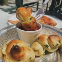 Garlic Knots · Knotted twists drizzled in olive oil, garlic, and parsley.