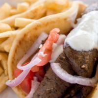 Gyro Sandwich · Gyro meat wrapped in a pita with tomatoes, red onions, and tzatziki sauce.