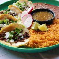 Street Tacos · 4 double corn tortilla stuffed with your choice of meat, rice, and beans. Garnished with tra...