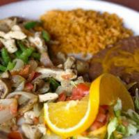 Fajitas de Pollo · Chicken breast strips marinated in our special fajita sauce and served sizzling with sautéed...