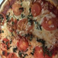 Margarita Pizza · Fresh homemade pizza sauce, fresh tomatoes, fresh basil, fresh garlic, Parmesan and mozzarel...