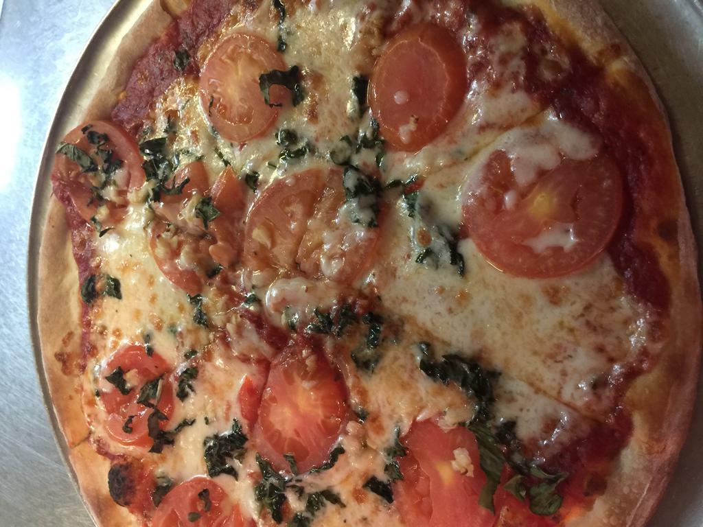 Margarita Pizza · Fresh homemade pizza sauce, fresh tomatoes, fresh basil, fresh garlic, Parmesan and mozzarella cheese.
