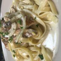 Fettuccini Carbonara · Sauteed bacon and onions with Alfredo sauce over fettuccini pasta with cooked broken egg. Ad...