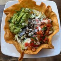 Taco Salad  · Served in a Crispy Fried Flour Tortilla filled with choice of protein, refried beans, lettuc...