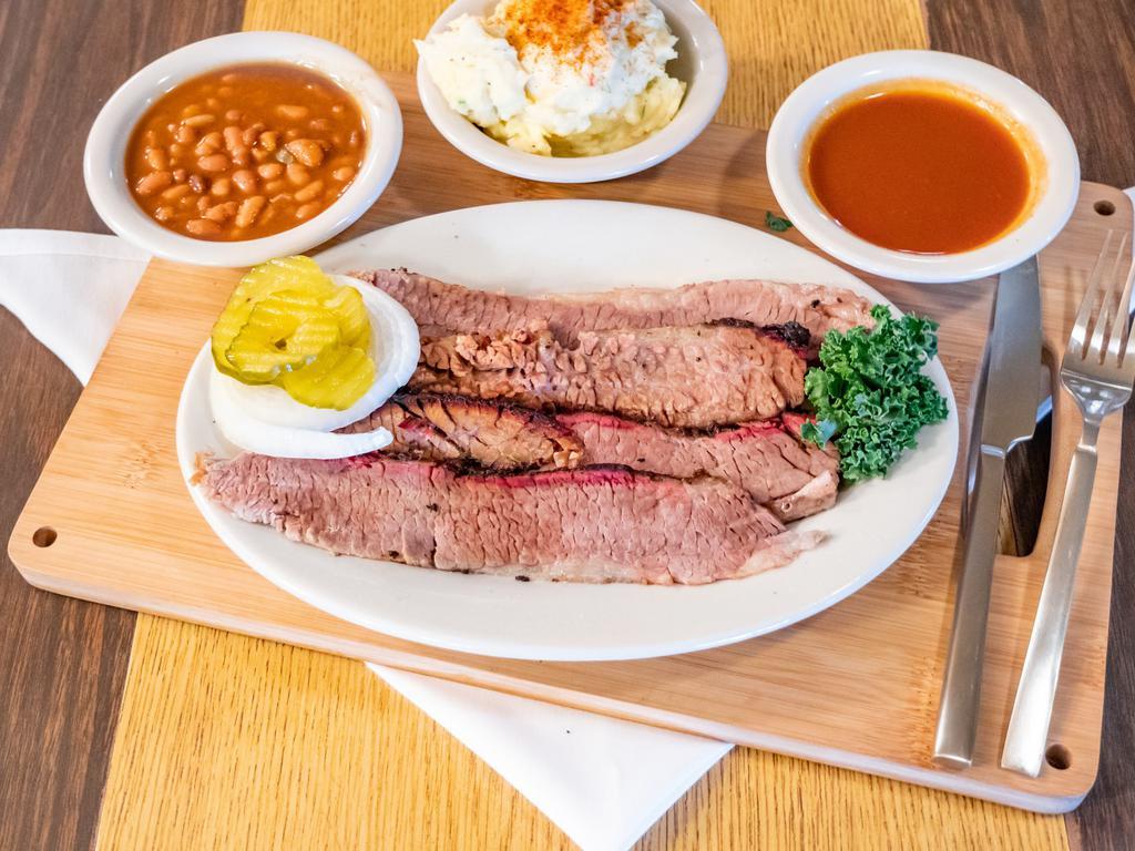 Beef Brisket · Sliced brisket with sauce, pickles, onion, baked beans and potato salad.